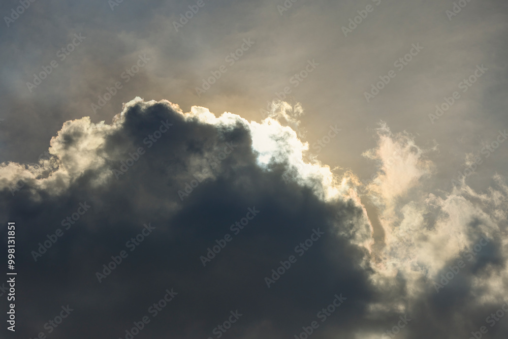 landscape with dramatic clouds in front of the sun landscape with dramatic clouds in front of the sun