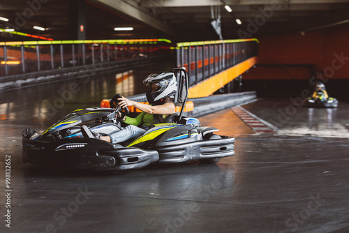 Woman Driving Go-Kart on Indoor Track in Racing Action