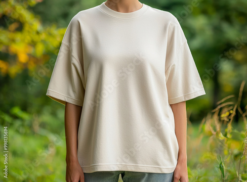 Woman wearing a casual beige oversized t-shirt outdoors. photo