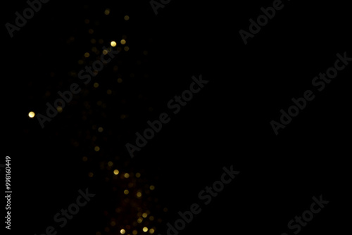 Golden blurred bokeh lights on black background. Glitter sparkle stars for celebrate. Overlay for your design