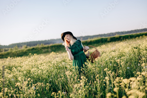 Wallpaper Mural A woman wearing an elegant green dress gracefully holds a basket in a blooming flower field Torontodigital.ca