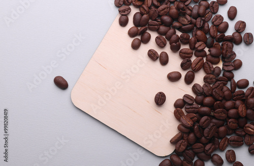 Wallpaper Mural Wooden square drink coaster with coffee beans on gray background Torontodigital.ca