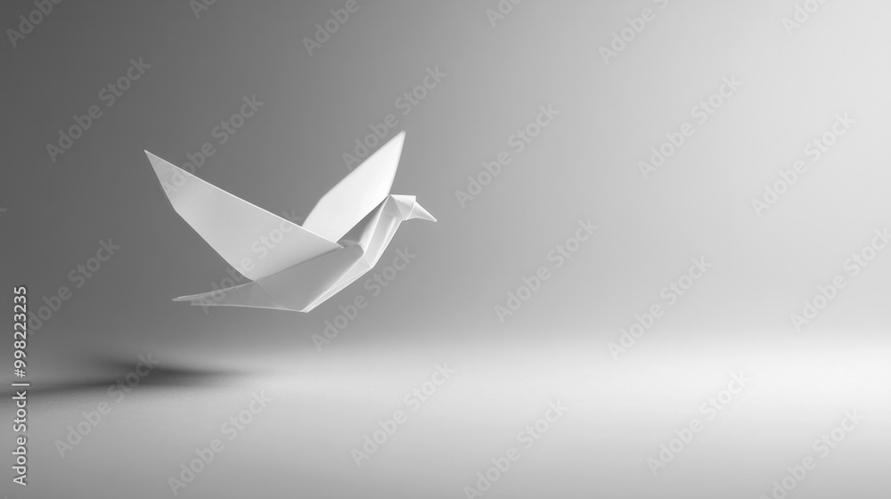 Naklejka premium A white paper bird is flying in the air