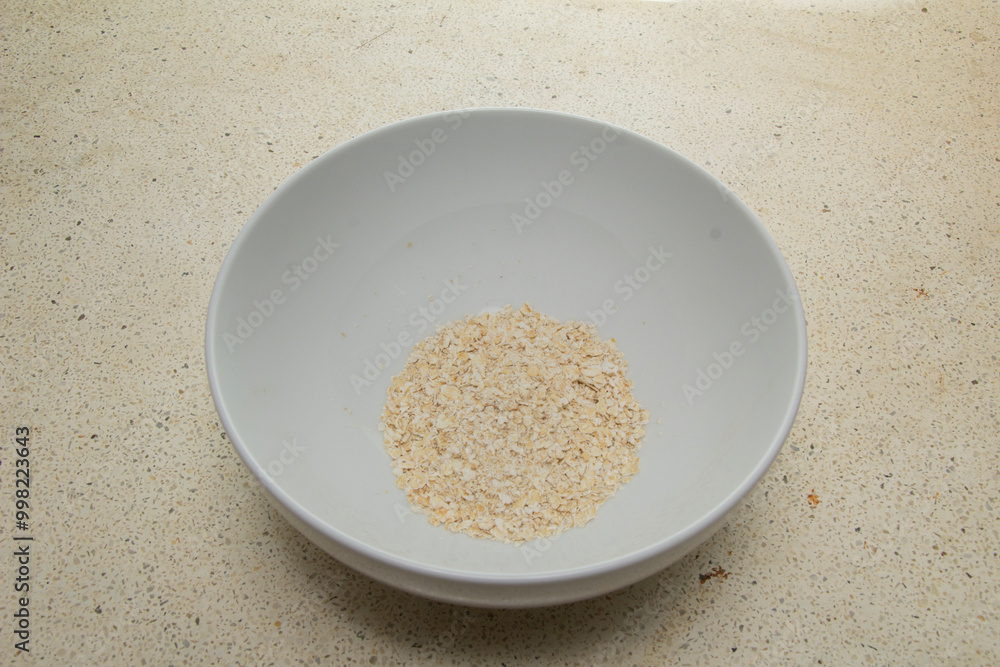 a bowl of leftover oatmeal isolated on the table, top view a bowl of leftover oatmeal isolated on the table, top view