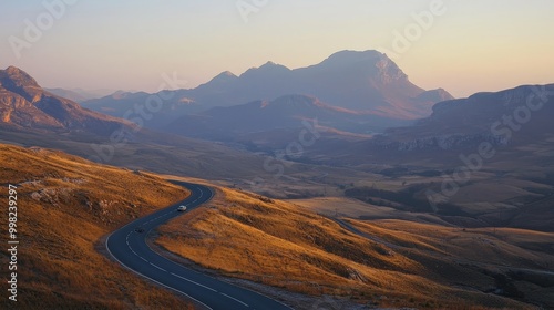 Serenity in Motion: Winding Roads Through Majestic Mountain Ranges During Golden Hour Capturing Nature's Tranquil Beauty