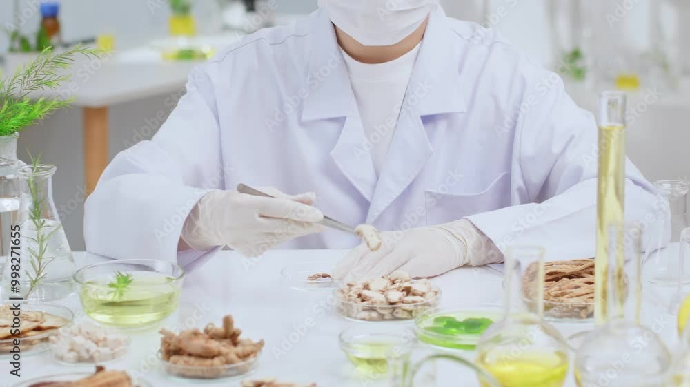 An experiment about oriental herbal medicine is conducting by a professional scientist in modern laboratory. Front view footage for product commercial video, which made from natural ingredient An experiment about oriental herbal medicine is conducting by a professional scientist in modern laboratory. Front view footage for product commercial video, which made from natural ingredient