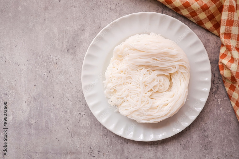 Thai rice noodle in white plate on grey background , top view food table , thai called Khanom Jeen Thai rice noodle in white plate on grey background , top view food table , thai called Khanom Jeen