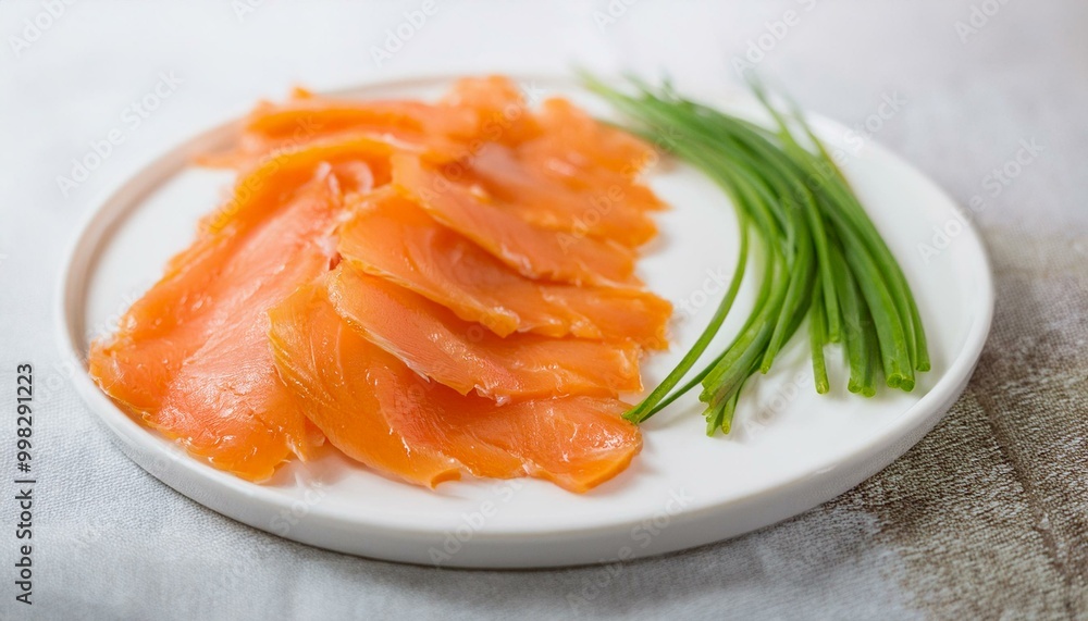 Smoked salmon on a white plate with chives. Smoked salmon on a white plate with chives.
