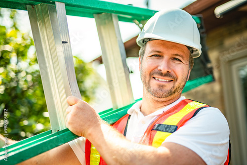 inspector or engineer with ladder checking the building structure and house roof specifications.