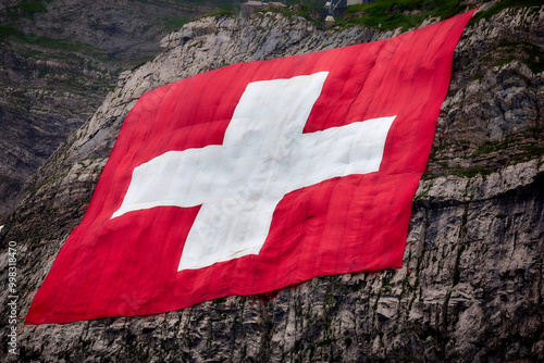 Schweizer Fahne aufgespannt auf einem Felsen zum Nationalfeiertag in der Schweiz photo