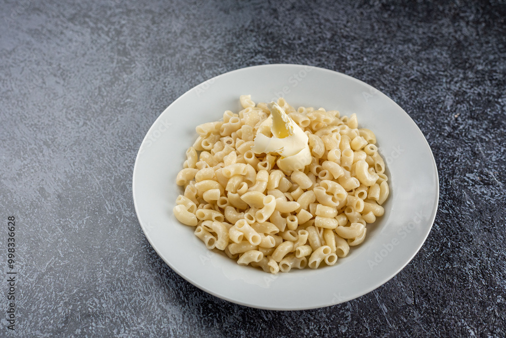 Pasta on a white plate on a gray background Pasta on a white plate on a gray background