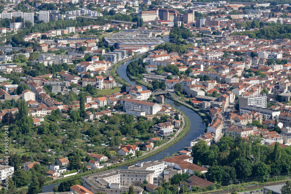 Fototapeta premium Nancy, France - September 21th 2024 : View Nancy metropolis seen from the 16th floor of the Panoramic Tower with the Marne-Rhine canal winding through the middle of the city.