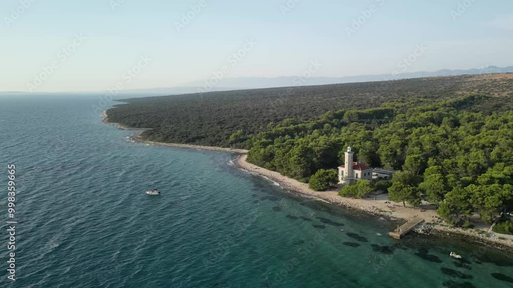 An aerial over island Vir in Croatia with lighthouse Lantern and green pine forest, beach. An aerial over island Vir in Croatia with lighthouse Lantern and green pine forest, beach.