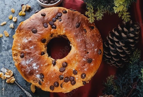 Panettone with chocolate on a  gray background with Christmas elements.  photo