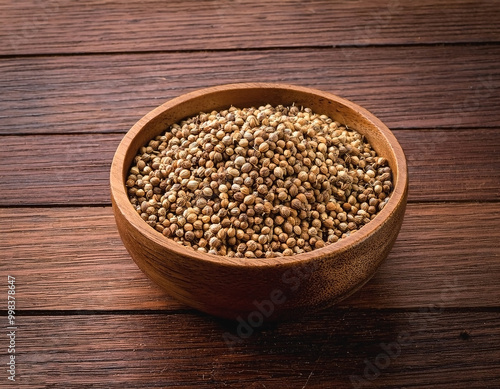 Coriander seeds isolated over wooden background