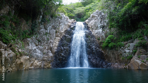 cascading waterfall plunging into serene pool, surrounded by lush greenery and rocky cliffs, creates tranquil and picturesque scene. natural beauty evokes sense of peace and relaxation