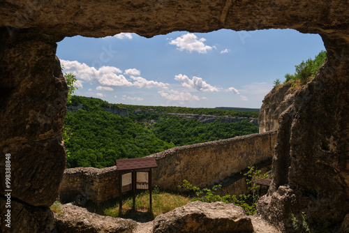 framed by the rocky entrance of an ancient stone structure photo