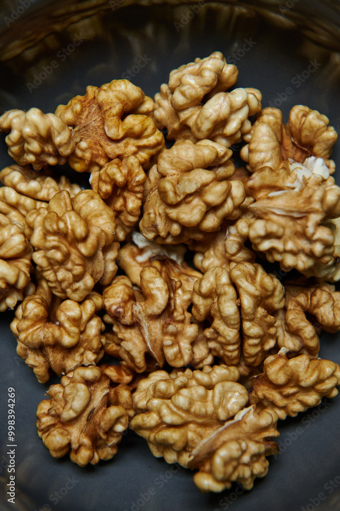 Close-up of Organic Walnut Kernels in a Bowl. Healthy eating and vegan concept. Close-up of Organic Walnut Kernels in a Bowl. Healthy eating and vegan concept.