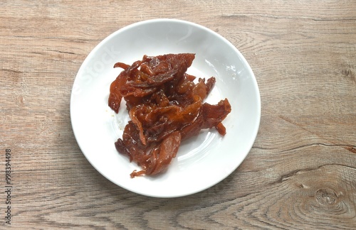 salty and sweet dry fried slice pork meat fermenting in sesame oil on plate