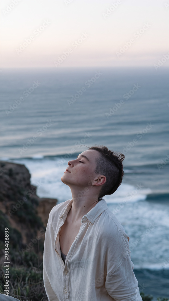 Serene Individual Embracing Ocean Breeze at Cliffside Sunset Viewpoint Serene Individual Embracing Ocean Breeze at Cliffside Sunset Viewpoint