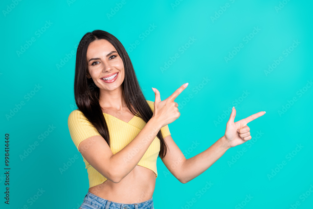Portrait of pretty young woman direct fingers empty space wear top isolated on turquoise color background Portrait of pretty young woman direct fingers empty space wear top isolated on turquoise color background