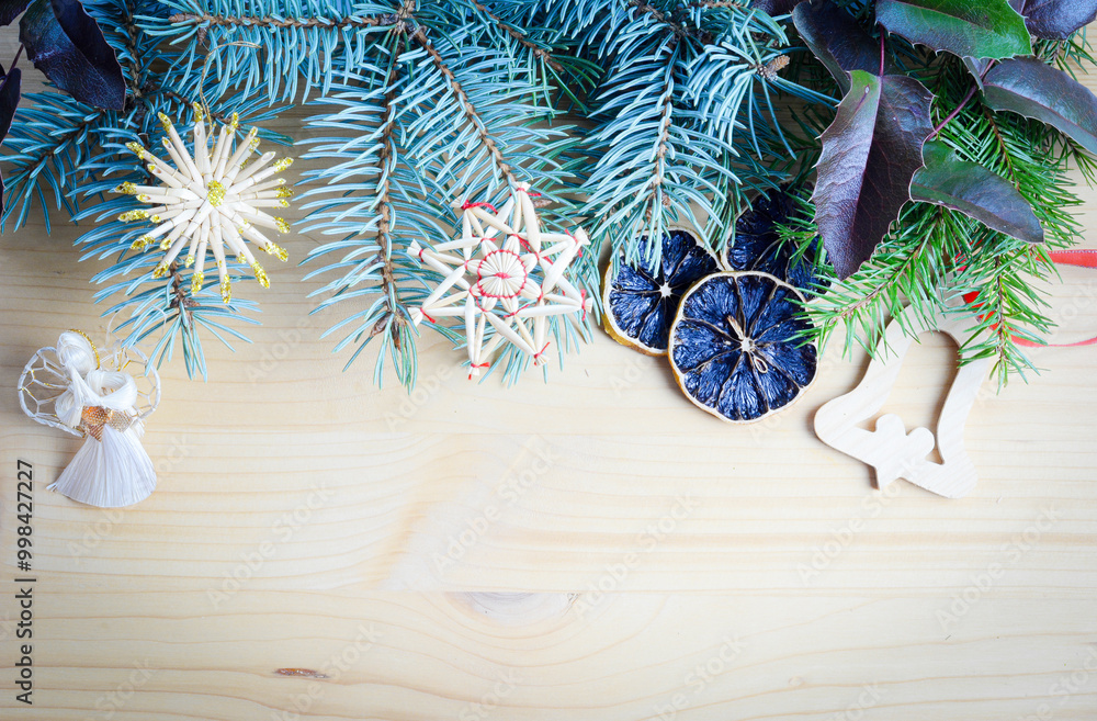 Christmas frame of spruce, natural christmas decorations on wooden background. Copy space. New Year lights. Flat lay. Christmas frame of spruce, natural christmas decorations on wooden background. Copy space. New Year lights. Flat lay.
