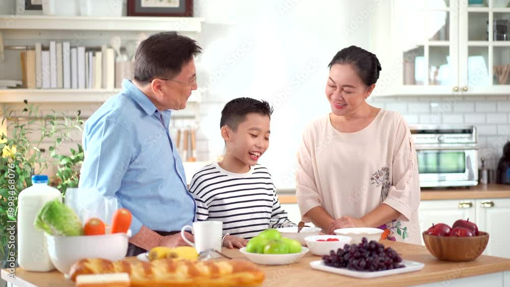 Happy Asian family is having a breakfast together. Happy Asian family is having a breakfast together.