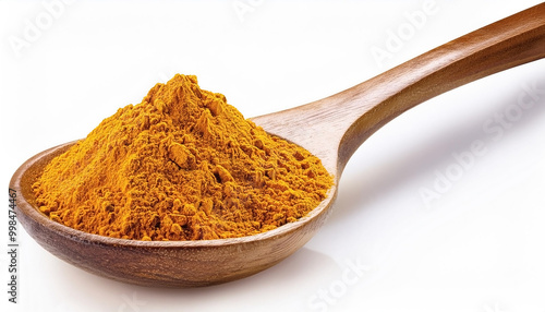 turmeric powder in wooden spoon over white background