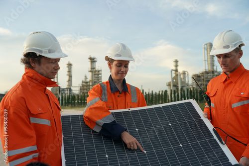 engineer in helmet installing solar panel system outdoors. Concept of alternative and renewable energy. photo