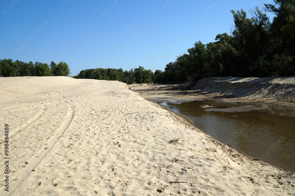 A sandy shore-beach of a small river A sandy shore-beach of a small river