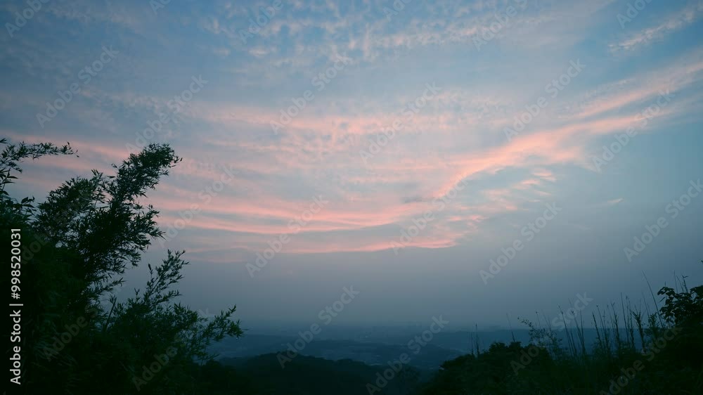 A peaceful evening scene with a soft, pastel sky. The clouds are gently drifting across the horizon, casting a warm glow over the landscape. Captured at sunset in Dading Mountain, Shulin, Taiwan. A peaceful evening scene with a soft, pastel sky. The clouds are gently drifting across the horizon, casting a warm glow over the landscape. Captured at sunset in Dading Mountain, Shulin, Taiwan.
