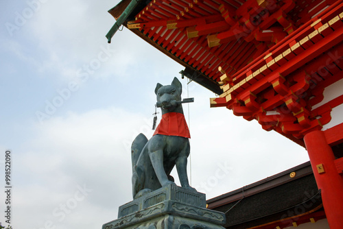 Bronze kitsune fox statue at Fushimi Inari Taisha shrine gate in Kyoto