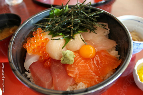 Japanese seafood rice bowl with salmon tuna and scallops