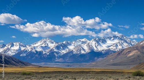 A stunning view of snow-capped mountains against a bright blue sky.