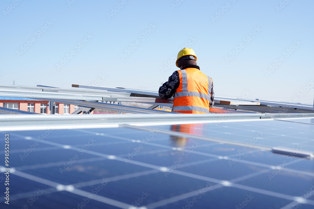 Workers install solar photovoltaic panels Workers install solar photovoltaic panels