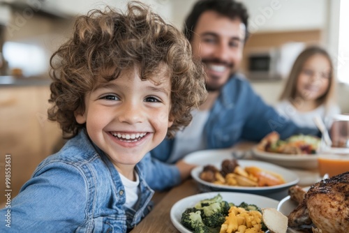 A father and his young child share a wholesome meal together, featuring green vegetables, pasta, and some protein, set in a cozy home kitchen environment.