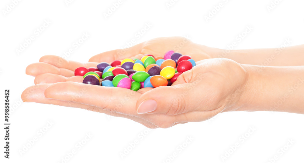 Woman hand holds lot of color candies, isolated on transparent background, fast food concept Woman hand holds lot of color candies, isolated on transparent background, fast food concept