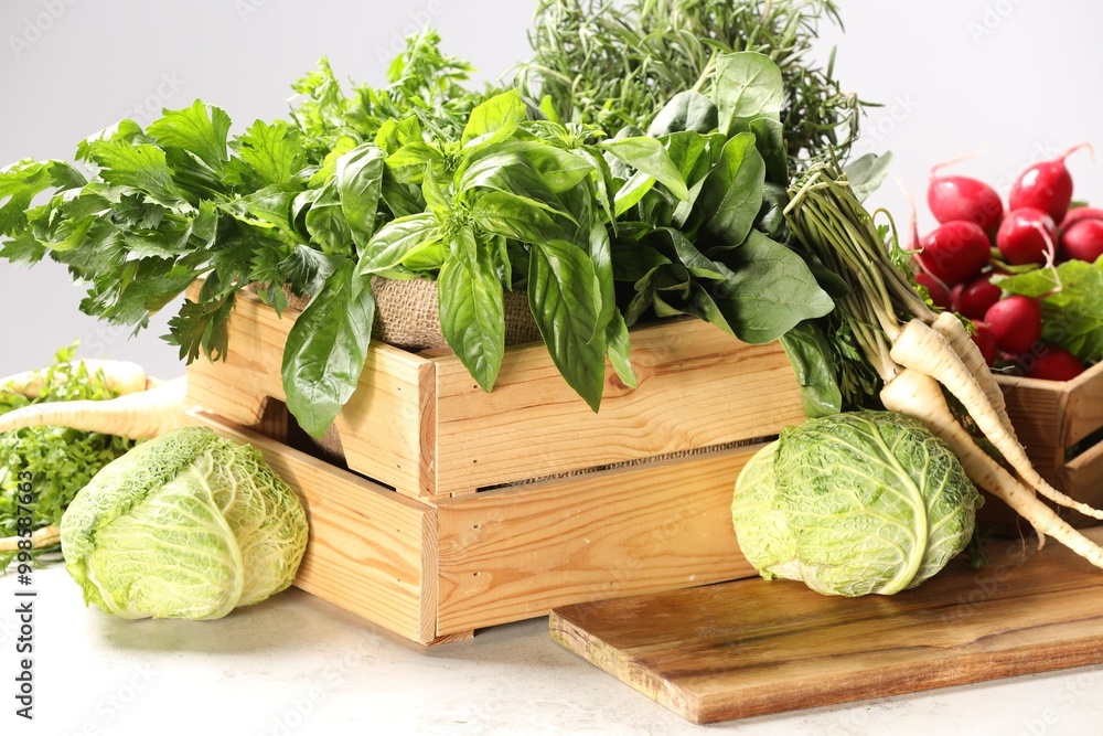 Different fresh herbs, cabbages and radishes on white table Different fresh herbs, cabbages and radishes on white table