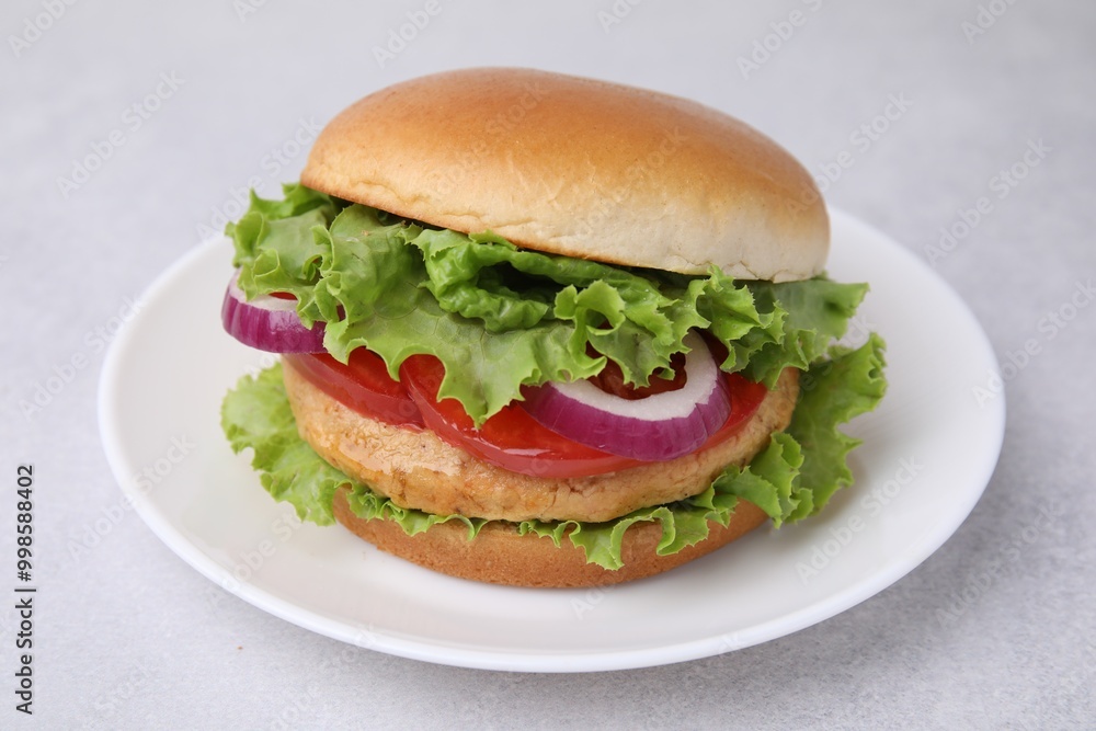 Delicious vegetarian burger with chickpea cutlet on light table, closeup Delicious vegetarian burger with chickpea cutlet on light table, closeup