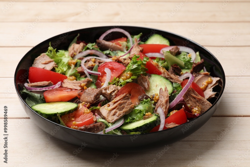 Delicious fresh tuna salad on wooden table, closeup Delicious fresh tuna salad on wooden table, closeup