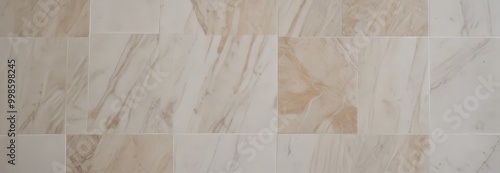 a close-up view marble floor composed of square tiles, with a light beige color and a subtle pattern of darker beige and white marble