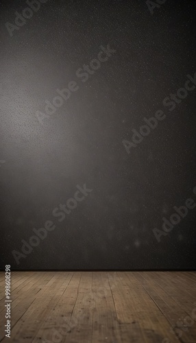 A dark, empty room with a wooden floor and a black wall in the background