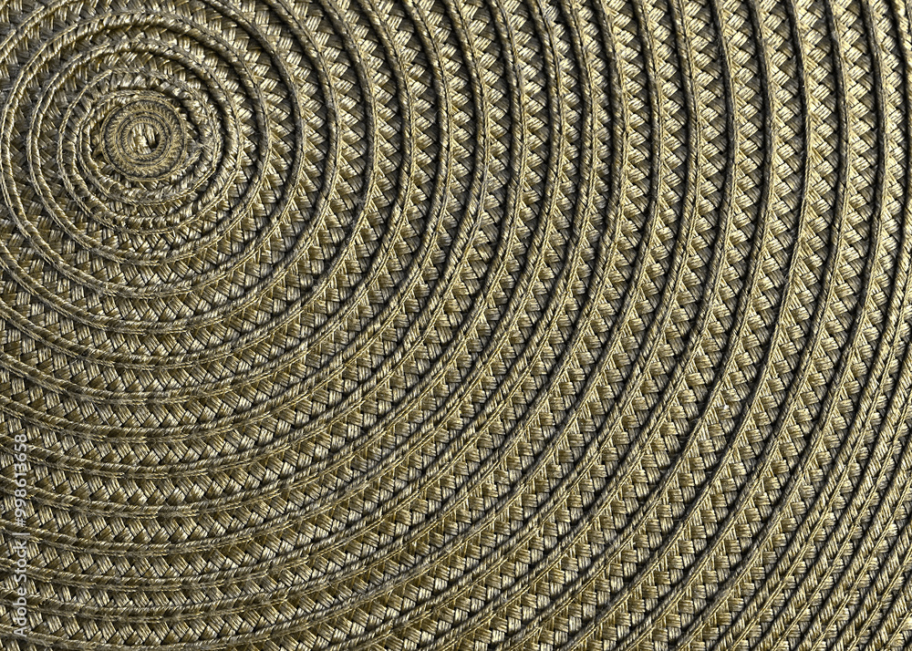 Fototapeta premium A table mat with spiral design closeup in gold