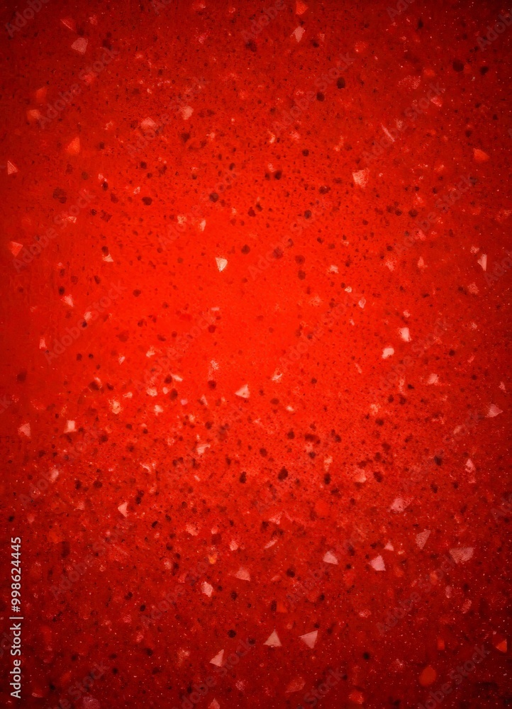 a close-up view red surface with small, irregularly shaped white and black speckles scattered across it, creating a textured and abstract pattern a close-up view red surface with small, irregularly shaped white and black speckles scattered across it, creating a textured and abstract pattern