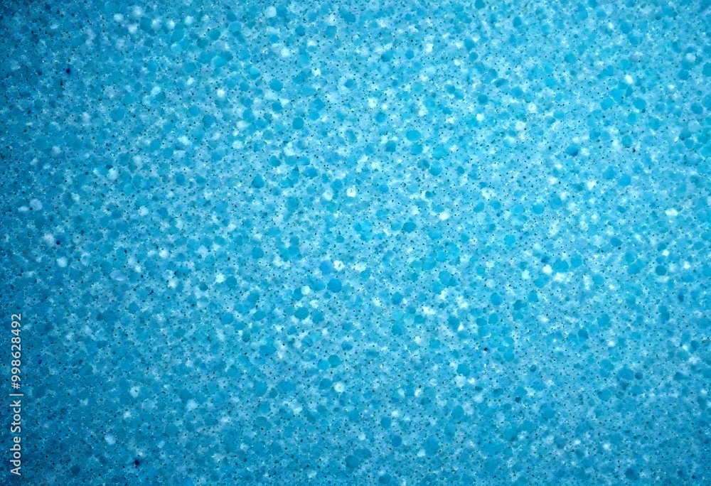 Obraz premium a close-up view textured surface with a blue-green hue, resembling a sponge or foam material
