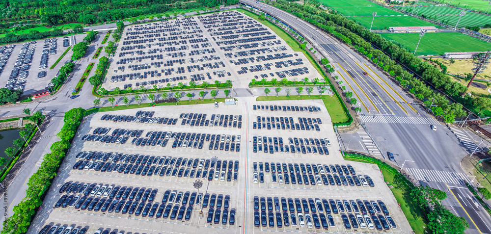 Fototapeta premium Aerial view of large parking lot in modern city