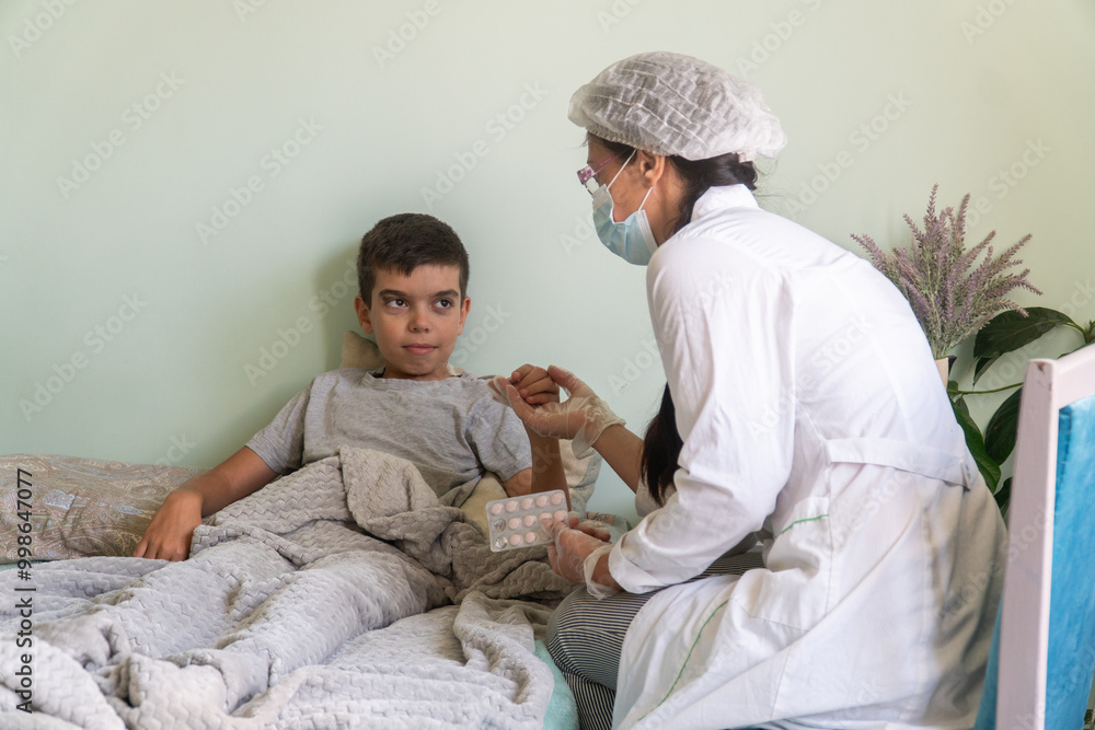 nurse at home looks at the boy's throat, the boy is sick, a doctor in a mask comes to a home call, viral serious disease, treatment, child, baby, kid, covid, lockdown, disease, virus nurse at home looks at the boy's throat, the boy is sick, a doctor in a mask comes to a home call, viral serious disease, treatment, child, baby, kid, covid, lockdown, disease, virus