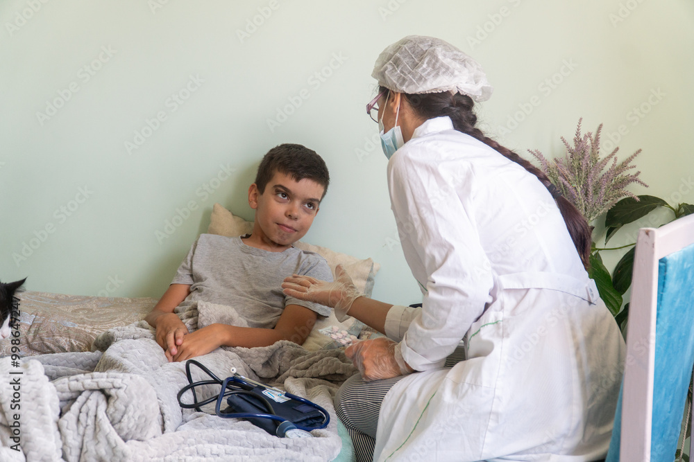 nurse at home looks at the boy's throat, the boy is sick, a doctor in a mask comes to a home call, viral serious disease, treatment, child, baby, kid, covid, lockdown, disease, virus nurse at home looks at the boy's throat, the boy is sick, a doctor in a mask comes to a home call, viral serious disease, treatment, child, baby, kid, covid, lockdown, disease, virus