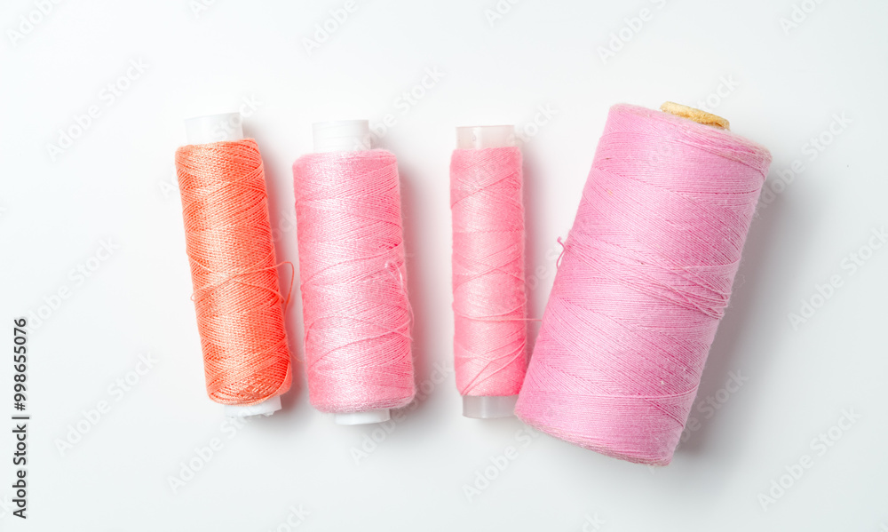 Pink thread spools on white background. Pink thread spools on white background.