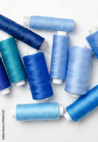 Blue thread spools on white background.